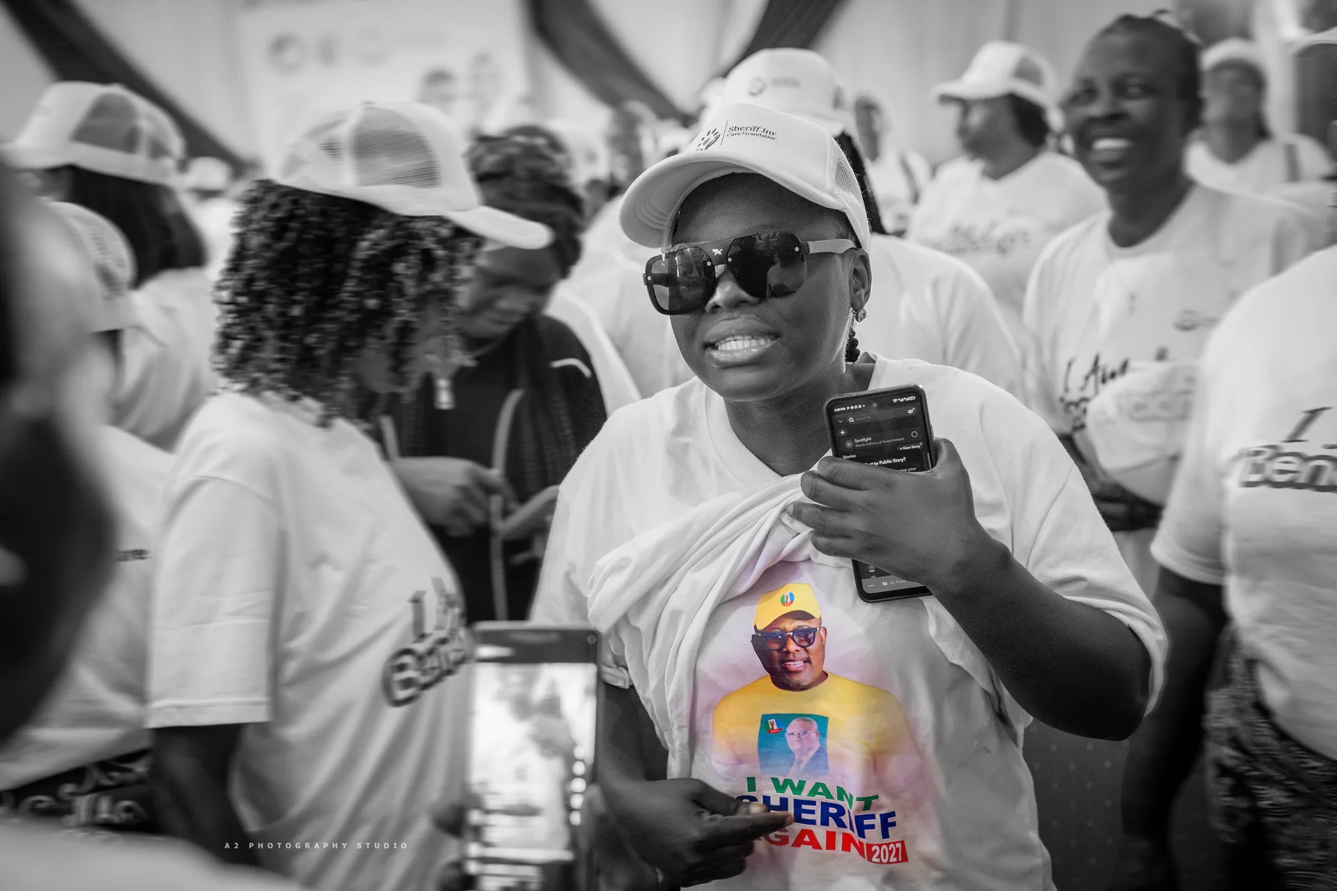 An attendee capturing a moment on a phone.